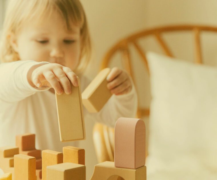 Child Building with Wooden Colored Blocks