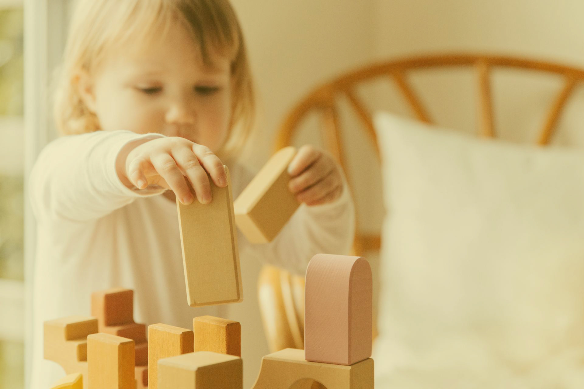 Child Building with Wooden Colored Blocks